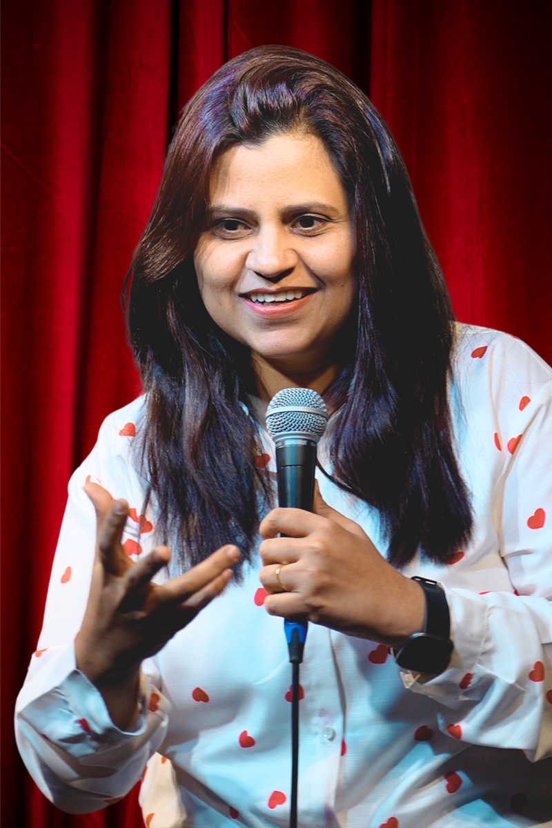 Akhilee Matta performing stand up comedy on stage